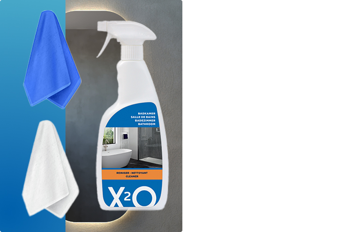 Produit nettoyant X²O pour salle de bains avec deux chiffons en microfibre bleus et blancs devant un miroir éclairé, idéal pour garder les miroirs X²O brillants et sans traces.